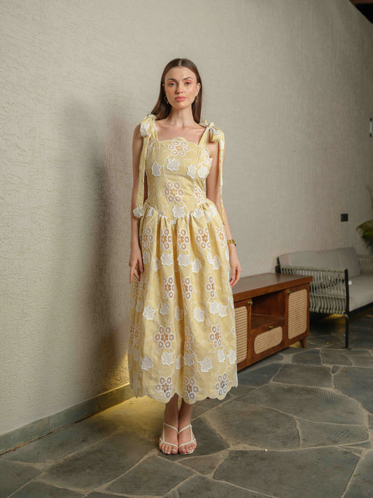 BREZELLA – A cutwork drop-waist dress featuring tie-up straps at the shoulders.