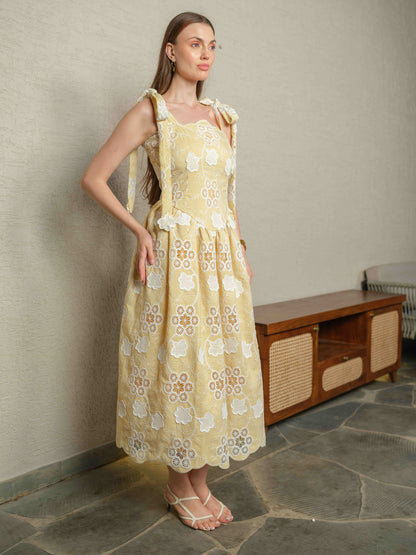 BREZELLA – A cutwork drop-waist dress featuring tie-up straps at the shoulders.