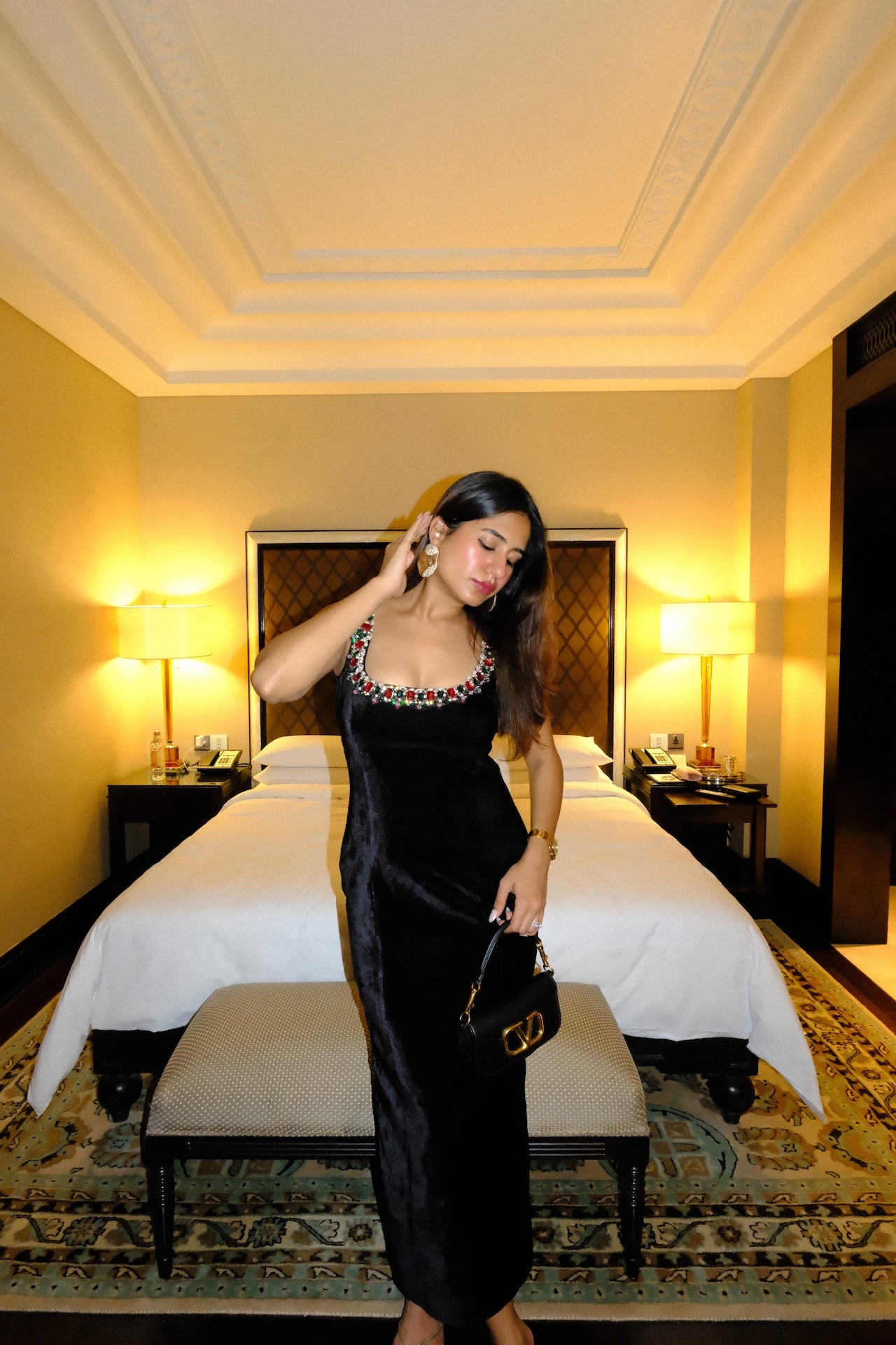 KAYA - A sleek black velvet bodycon dress with an elegant jewel-work neckline.