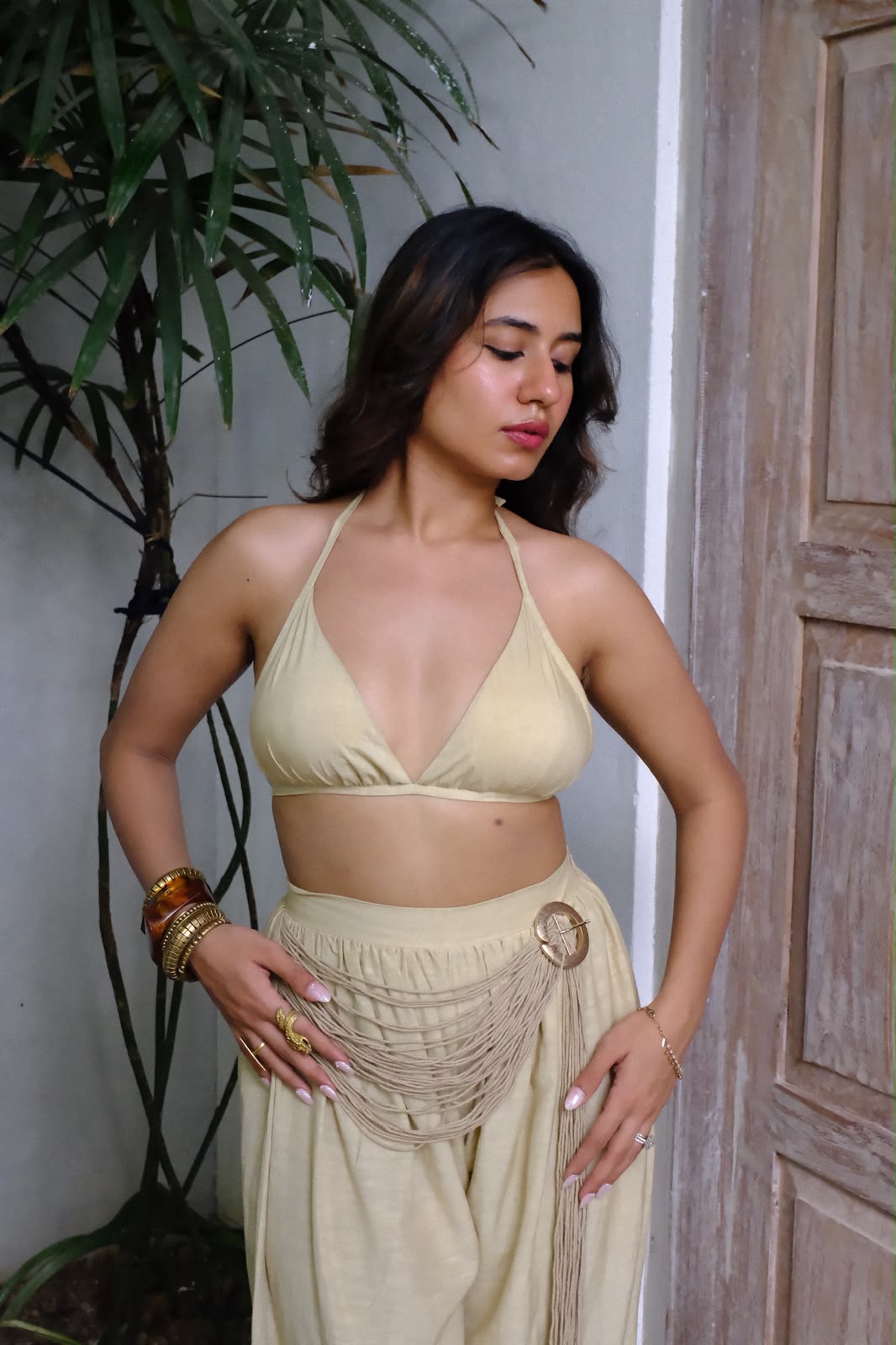 Aaranya - A chic buff bralette top paired with relaxed harem pants, featuring intricate rope and buckle detailing.