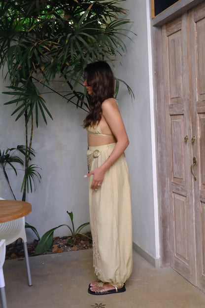 Aaranya - A chic buff bralette top paired with relaxed harem pants, featuring intricate rope and buckle detailing.
