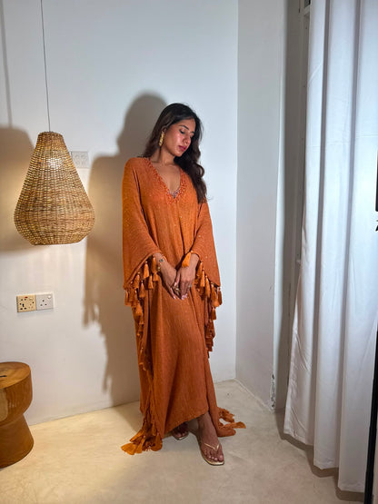 SOL — A vibrant orange kaftan with intricate V-neck detailing, paired with a graceful statement dupatta.
